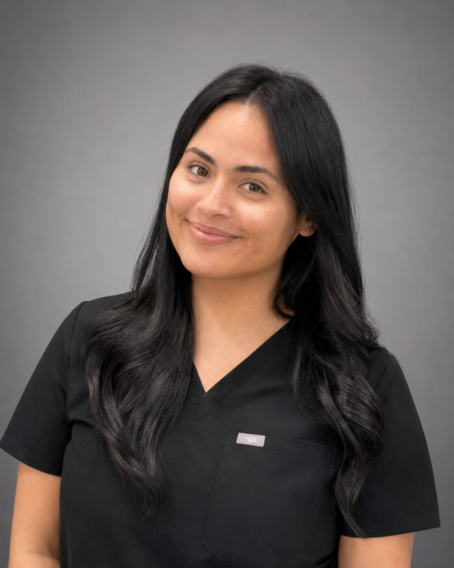 Portrait of Azia, dental office team member with long dark hair smiling