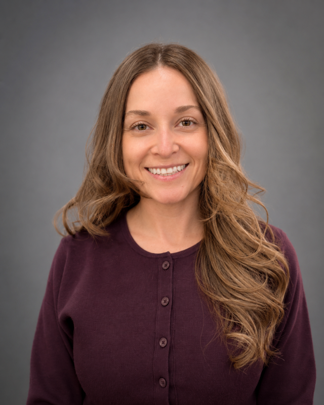 Portrait of Heidi, dental team member smiling in professional attire